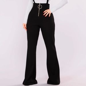 Black overalls with flare pants and a zipper. Never wore it